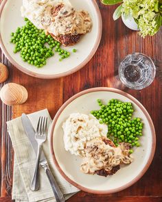 two plates with meat, mashed potatoes and peas