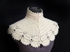 a white crocheted collar on top of a mannequin's torso