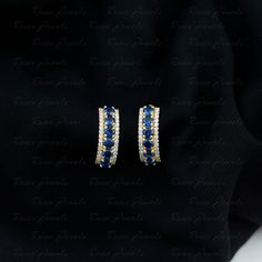 Product Details Choose to spill your charm by wearing these gleaming J hoop earrings. These earrings are embellished with round cut created blue sapphire and moissanite studded both side in parallel, making these earrings much more desirable. These created blue sapphire are worth getting for the lady you love. Product Information SKU SHP-EARRINGS082210080 Length 15.3 mm Width 5.2 mm Height 10.5 mm Weight 2.99 gm LAB CREATED BLUE SAPPHIRE INFORMATION No.of Stones 12 Pieces Total Weight 1.80 Carat J Hoop, Half Hoop Earrings, Classic Accessories, Precious Gemstones Jewelry, Pretty Earrings, Huggie Hoop Earrings, The Lady, Mom Birthday Gift, Gold Hoop