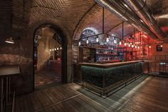 a dimly lit bar in an old brick building