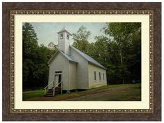 an old white church with a steeple and stairs