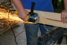 a man using a grinder to cut wood with an electric sawtoothing machine