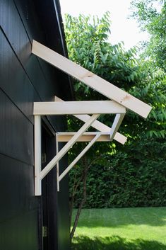 an open window on the side of a black house