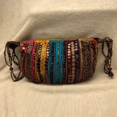 Beautiful Colors! Unique Bag. Blue, Purple, Pink, Orange Tofee, Red, Gold And Brown With Multicolor Beads Covering Purse. Beaded Straps. Zip Closure With Snap To Consolidate Bag Into Smaller Size To Be Carried As A Hand Bag. 10" X 8". Looks New. Never Used. Logo Inside. Everyday Beaded Pouch Bag, Beaded Shoulder Bag Clutch, Embroidered Multicolor Evening Shoulder Bag, Evening Embroidered Multicolor Shoulder Bag, Embellished Pouch Bag For Everyday Use, Embellished Everyday Pouch Bag, Multicolor Embroidered Handheld Evening Bag, Embroidered Multicolor Handheld Evening Bag, Multicolor Embellished Shoulder Bag For Everyday