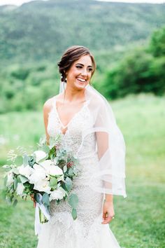 a woman in a wedding dress holding a bouquet