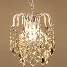 a white chandelier hanging from a ceiling