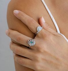 a close up of a person's hand with a ring on her left arm