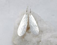 "Silver Teardrop Earrings- Large Hammered Teardrop Earrings- Hammered Double Teardrop Earrings- Sterling Silver Dangle Earrings These sterling silver earrings were inspired by the simple curved line of a water droplet. They are handmade from solid sterling silver. I hammered and tumbled them for strength and then polished them for a shiny finish. This hammered texture glistens beautifully in the light. Earrings will arrive gift-wrapped Small Teardrop dimensions: Height 1\" x Width 1/3\" (26mm x Lariat Necklace Silver, Long Silver Earrings, Hammered Earrings, Light Earrings, Silver Dangle Earrings, Sterling Silver Dangle Earrings, Large Earrings, Hammered Silver, Silver Drop Earrings