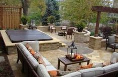 an outdoor living area with couches, tables and chairs in the middle of it