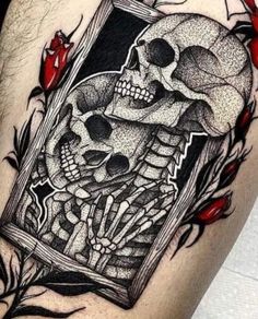 a man's thigh with skulls and roses on it, in the shape of a book