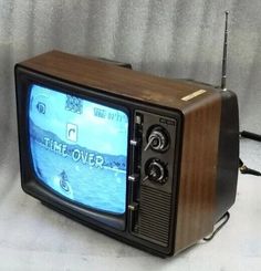 an old fashioned television with the time over on it