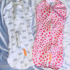 two baby swaddles laying next to each other