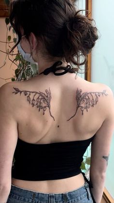 a woman with a tattoo on her back