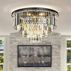 a living room filled with furniture and a chandelier hanging from the ceiling over a fire place