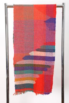 a multicolored piece of cloth hanging from a metal frame