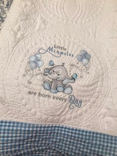 a blue and white quilt with an elephant on it's side that says, little miss angel baby are born every day