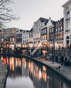 a river running through a city next to tall buildings