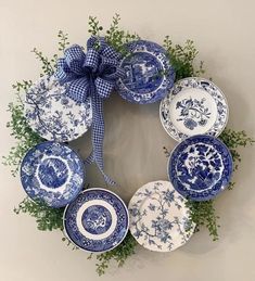 a wreath made out of blue and white plates