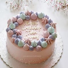 a birthday cake decorated with seashells on a table