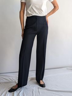 Women's high-rise navy wool pleated trousers with a front zip and button fastening and thick wool fabric. These trousers are ideal for a minimalist work style. Brand: Louis International - made in Italy Year: 1980s Fabric: Wool Vintage condition: good - four tiny holes at the front that are barely noticeable when worn. Please refer to the pictures for details. Waist 31 inches Hips 20 inches Inside Leg 32 inches Length 43 inches Classic Navy Full-length Bottoms, Classic Navy Full-length Pants, Navy Cotton Trousers, Blue Pull-on Trousers, Pleated Trousers, Pantalon Large, Wool Fabric, Work Fashion, Trousers Women