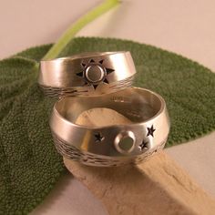 "There is nothing like seeing the moon's glint off water on a peaceful night, and in the morning...the sun is shining. Like Yin and Yang, night and day work together in a circle of life. What wonderful symbols for wedding bands! These rings have a soft brush finish, but could also be done in high polish. I have used oxidation, or antiquing to bring out the details. The width varies slightly in the design of both rings, which gives a truely custom feel. Both rings measure in width about 5/16\" wi Mystical Engraved Wedding Jewelry, Celestial Rings With Sun And Moon Design For Anniversary, Celestial Sun And Moon Design Rings For Anniversary, Engraved Moon Shaped Jewelry For Wedding, Spiritual Crescent Wedding Rings, Engraved Moon Shaped Wedding Jewelry, Celestial Rings With Sun And Moon Design For Promise, Celestial Promise Rings With Sun And Moon Design, Celestial Sun And Moon Design Promise Rings