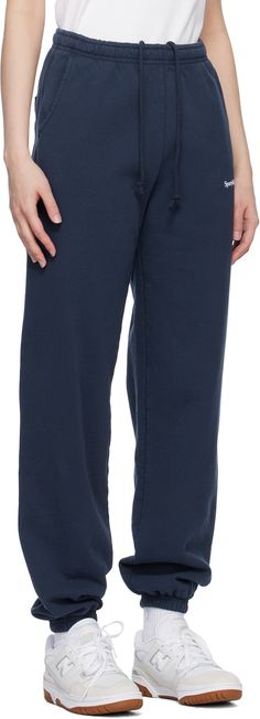 11.5 oz French terry lounge pants. · Concealed drawstring at elasticized waistband · Three-pocket styling · Logo flocked at front · Elasticized cuffs Supplier color: Navy/Cream Rich Clothes, Sporty And Rich, Lounge Pants, Luxury Streetwear, Tri Color, French Terry, Athleisure, Sweatpants, Lounge