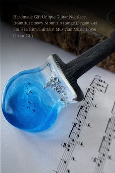 a close up of a paint brush on top of sheet music