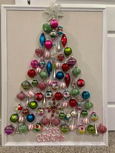 a christmas tree made out of ornaments in a frame