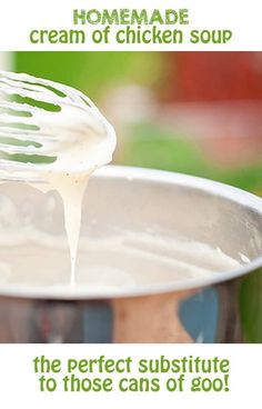 a hand holding a whisk over a metal bowl filled with white liquid and cream