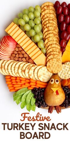 a turkey shaped cracker board with grapes, grapes, cheese, and other snacks