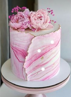 a pink marbled cake with flowers on top