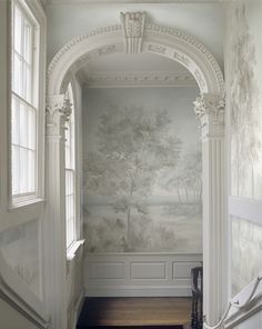 an entry way with wallpaper and stairs leading up to it