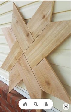 a wooden star on the side of a house