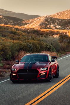 a red sports car driving down the road