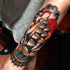 a man with a ship tattoo on his arm