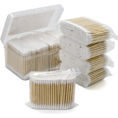 several matches are stacked in a plastic box on a white background, one is empty and the other is full of matches