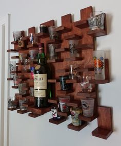 a wine bottle and glasses on a wooden shelf