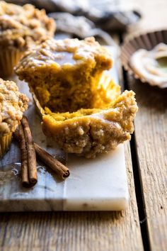 muffins on a cutting board with cinnamon sticks