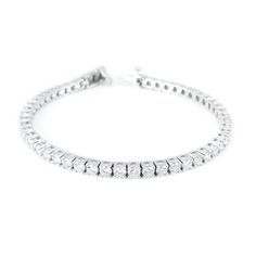 A tennis bracelet made out of 8 carats in round brilliant cut diamonds is an immaculate statement piece that is simple yet beautiful. Each stone is four prong set into the bracelet and are lined next to each other in links that allow for subtle movement of the entire piece like the links in a chain. The sparkling round cut diamonds in this tennis bracelet are simply eye-catching and the style is effortless, allowing for a brilliant accessory that is great for any kind of occasion or outfit.If you love wearing this bracelet, you will love our 5 carat diamond tennis bracelet. Product Information Metal: 14k Gold / 18k Gold / Platinum Setting: Four Prong Length: 7 inches Diamond Information Diamond Origin: Natural, Mined Diamond or Lab Created based on choice of Diamond Quality Total Carat Wei Gemstone Engagement Rings Sapphire, Custom Signet Ring, Gallery Jewelry, 3 Carat Diamond, Diamond Jewelry Necklace, Forever One Moissanite, Lab Grown Diamonds Engagement, Anniversary Jewelry, Gemstone Engagement