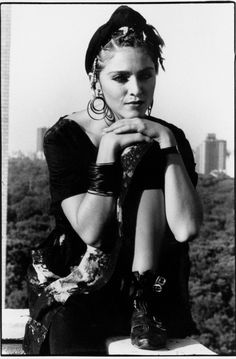 a black and white photo of a woman with her arms crossed