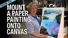 a woman holding up a painting in front of a wall with pictures on it and the words how to mount a paper painting onto canvass