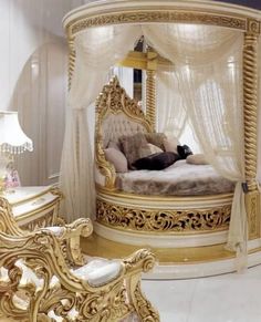 an elaborately decorated bedroom with gold furniture