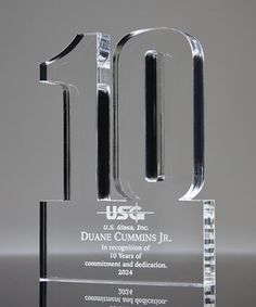 a clear glass trophy with the number 10 on it