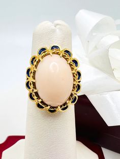 Beautiful 14K Yellow Gold Pink Coral & Blue Enamel Vintage Ring size 4.75 A perfect gift for your loved one for any special occasion or holiday! Total Ring Weight: 6.32g Ring Length: 27.05mm Ring Width: 17.88mm Gemstone: Pink Coral, Blue Enamel Item will be placed into a gift box. * Luxury Oval Cabochon Sapphire Ring As Gift, Cabochon Sapphire Ring Fine Jewelry Gift, Cabochon Sapphire Ring Gift, Luxury Cabochon Sapphire Ring Gift, Heirloom Style Formal Enamel Ring, Oval Gemstone Enamel Ring As Gift, Oval Enamel Gemstone Ring As Gift, Oval Enamel Ring With Gemstone As Gift, Oval Enamel Ring With Gemstone Gift