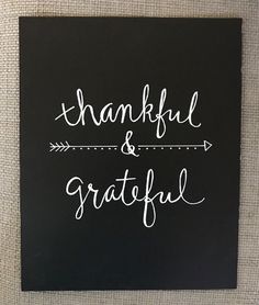 a black and white sign that says, thank and grateful with an arrow on it