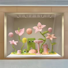 a display case filled with fake flowers and plants