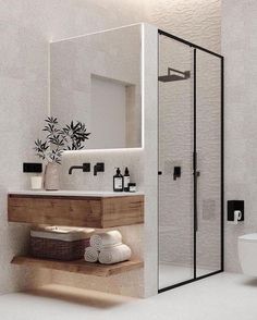 a bathroom with a toilet, sink and shower stall in it's own area