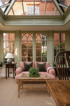 a living room filled with furniture and windows