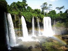 the waterfall is surrounded by rainbows and water cascading from it's sides