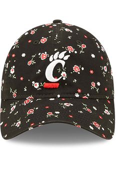 Dress like the most fashionable fan around with this Cincinnati Bearcats New Era Womens Black Floral 9TWENTY Adjustable Hat! This Cincinnati Womens Adjustable Hat features a front embroidered team logo on a lightly structured crown with floral design, pre-curved visor, and adjustable closure, so now everyone will know how much you love your Bearcats. Go Cincinnati! New Era Blossom LS 9TWENTY, team logo embroidered on front, team color undervisor, screen printed floral print throughout the hat, A Casual Baseball Cap For Spring Sports Events, Spring Casual Baseball Cap For Sports Events, Casual Cotton Hats For Fan Gear, Casual Hats With Curved Visor For Fan Gear, Casual Baseball Cap With Curved Brim For Fans, Casual Baseball Cap For Fan Merchandise, Casual Curved Brim Baseball Cap For Fans, Casual Cotton Baseball Cap Fan Merchandise, Casual Cotton Baseball Cap For Fans